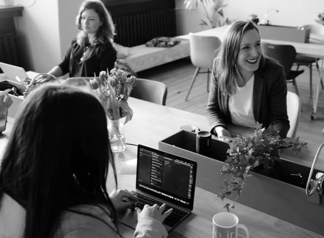 Image of people sitting together using laptops